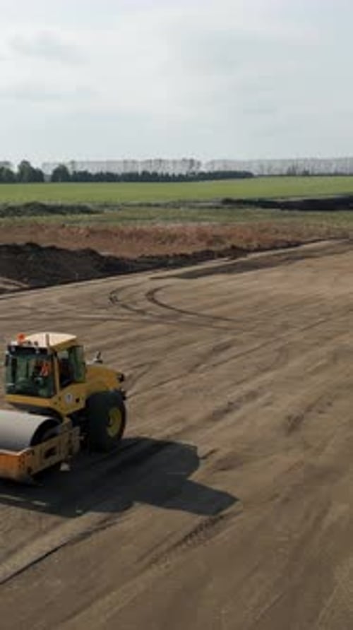Road Roller Flattening Ground at Construction Site Clip