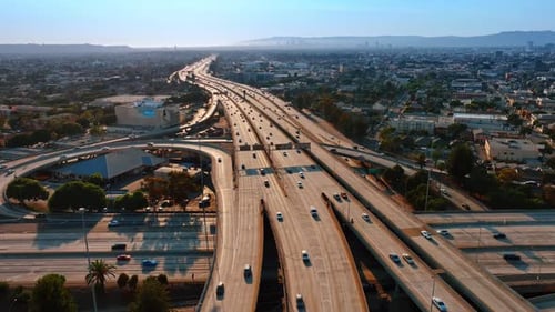 Sunlit highways with multiple cars moving by. Lively traffic in Los Angeles, California, USA.