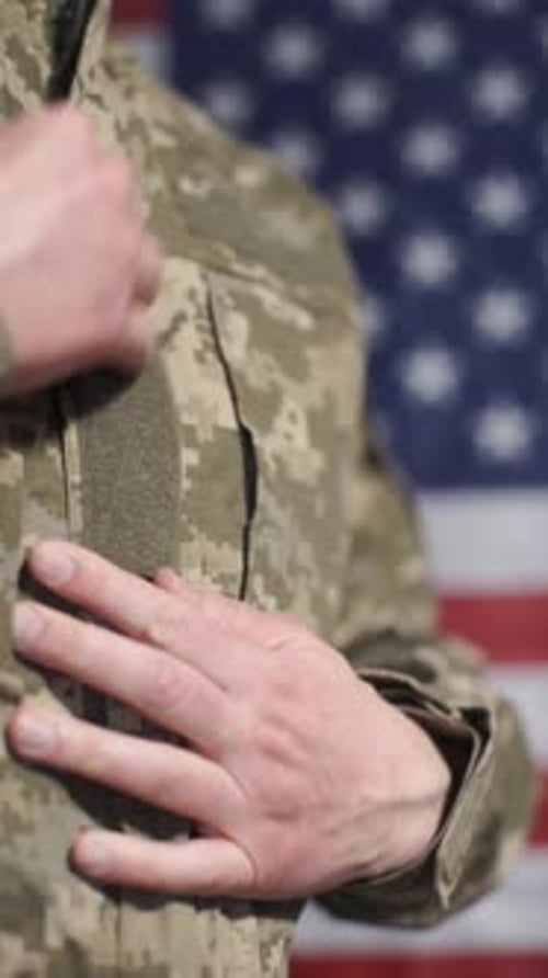 Man in Uniform Places Hand on Chest