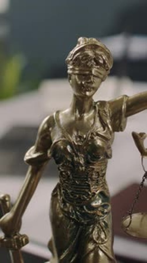 Vertical of Statue of Themis with Scales and Sword in Lawyers Office