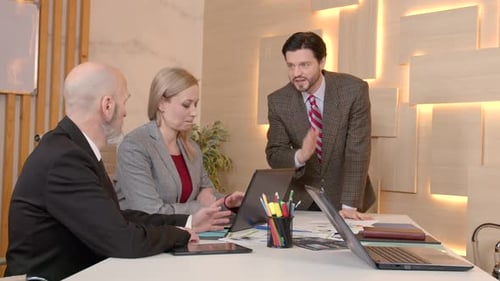 Friendly Male Executive and Diverse Business Coworkers Brainstorming at Office