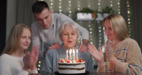 Family Celebrates Birthday with Cake and Candles