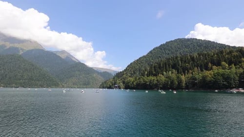 View of the Lake in the Mountains Clouds and Forest are Reflected in the Lake