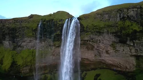 aerial panorama of Seljalandsfoss, displaying the powerful waterfall, meandering river, and vast
