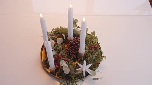 Turning Off Electric Candles on Christmas Advent Wreath White Background