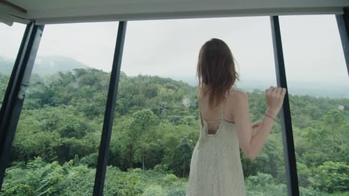 Woman Dancing in Modern House with Forest View