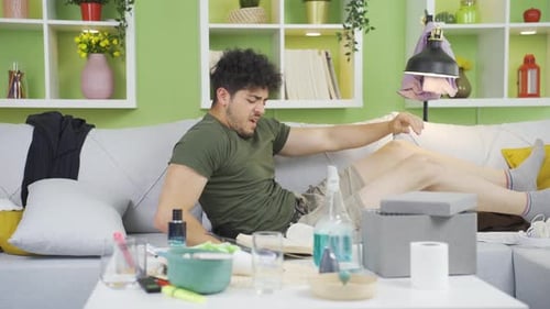 Young Man Waking Up on the Couch