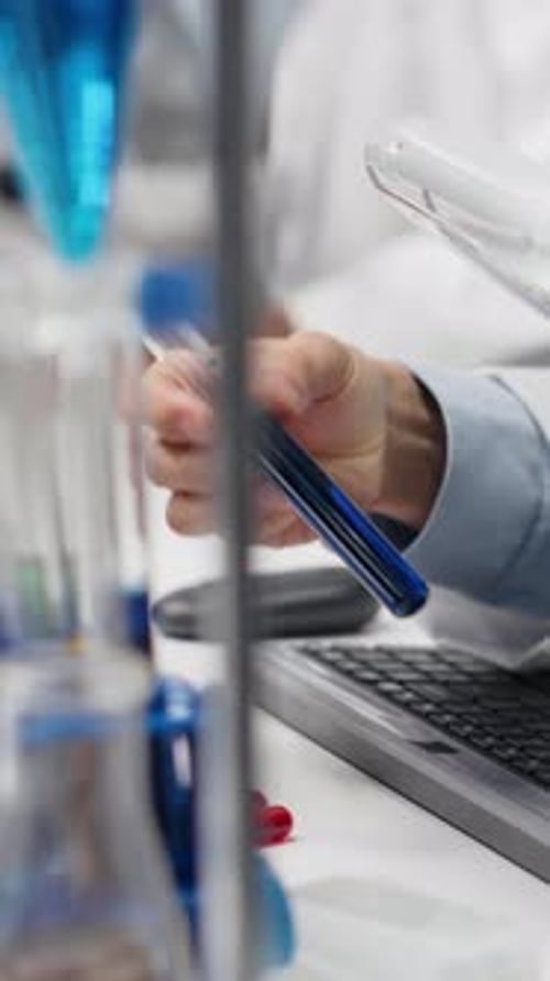 Scientist Holding Blue Liquid in Test Tube