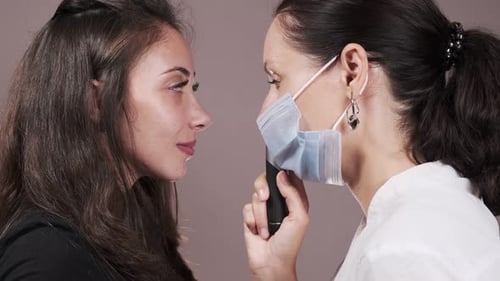 Eye Examination by Doctor Wearing Mask