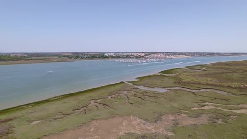 Motor boats sailing and white wakes in the estuary. Panoramic aerial view over boats in the water. A