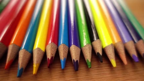 Brightly Colored Pencils Neatly Arranged on Wood Table