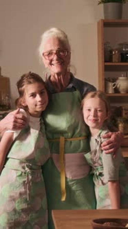 Woman and Girls Embracing in the Kitchen