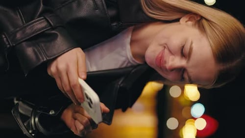 Woman Using Mobile Phone at Night in City