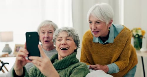 Senior Women Video Chatting On Smartphone Indoors