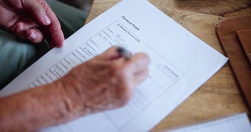 Adult Completing Pension Fund Form Close Up