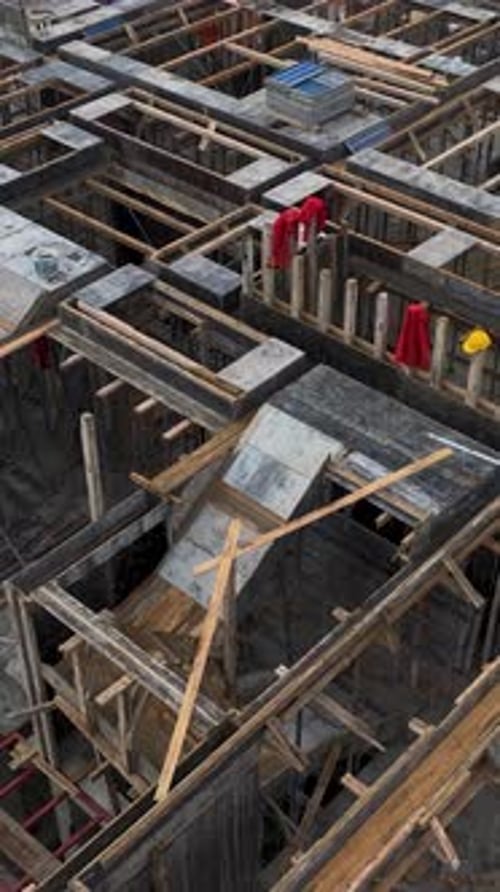 Vertical Video of New Building Exterior Built By Crane and Manual Tools