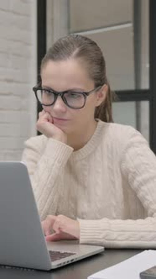 Woman Typing on Laptop at Desk Indoors
