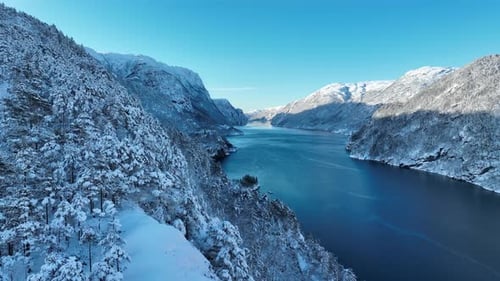 Remote Norway winter fjord landscape - Idyllic forward moving aerial in morning winter wonderland -