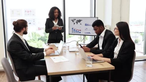 Business Team Reviewing Financial Charts in a Meeting Room