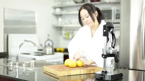 Woman Prepares Fresh Lemon Juice in Kitchen