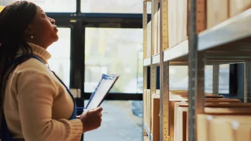 Woman Taking Inventory in a Warehouse