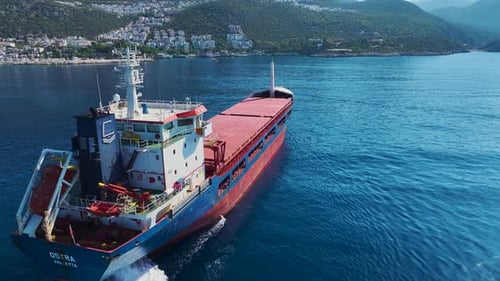 Aerial View Cargo Ship Anchoring in the Vast Dark Blue Sea With Gentle Waves