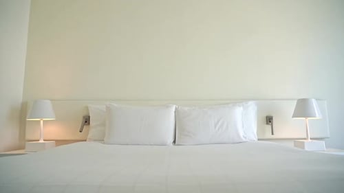 White candid and tidy double bed of hotel room. Tilt down