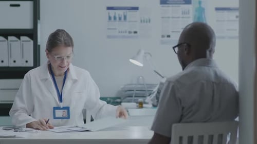 Friendly Doctor Consults with Patient in Office