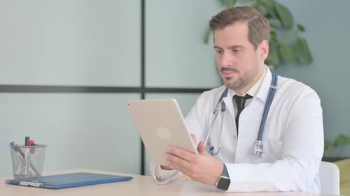 Male Doctor using Tablet in Clinic