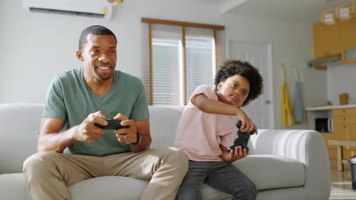 Father and Son Enjoy Playing Video Games Together