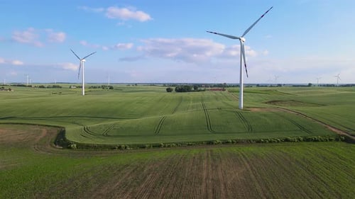 Wind Converted to Electricity By Wind Generator Farm Windmill with Spinning Blades in Countryside