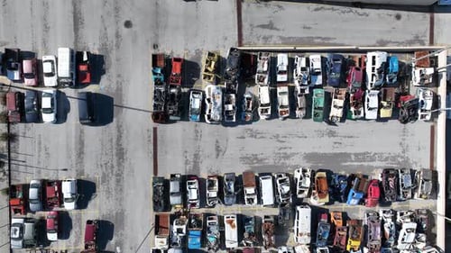 Aerial view of cars in car scrapyard with drone