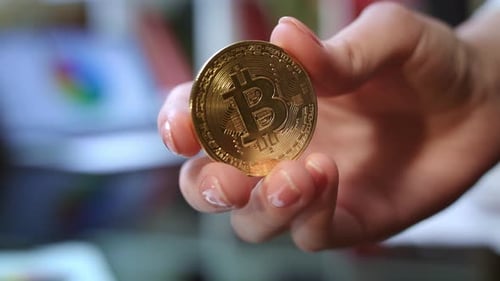 Bitcoin Business Concept. Close Up Of Gold Bitcoin In Hand. World Cryptocurrency Business. Invest...