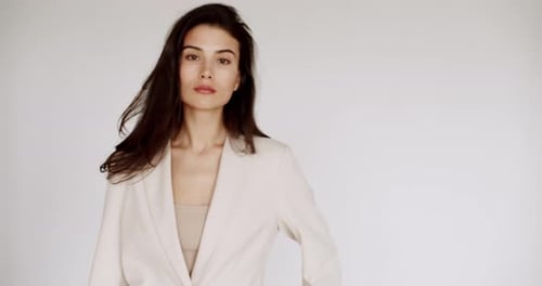 Woman Poses and Puts Hair Up Indoors