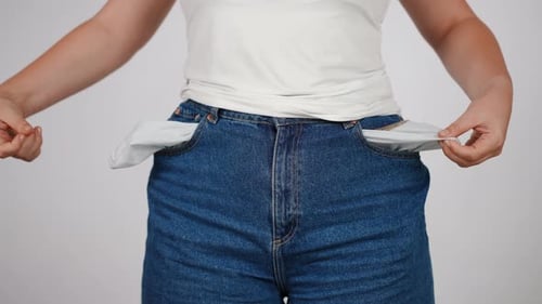 Person Showing Empty Blue Jean Pockets