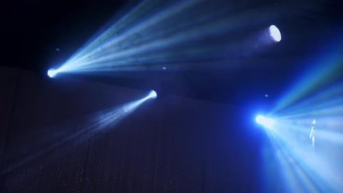 Dynamic Blue Stage Lighting with Smoky Atmosphere