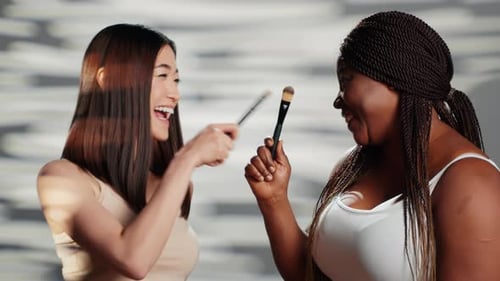 Happy Multiracial Girls Playing with Brushes in Studio