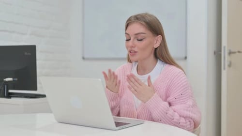 Blonde Woman Video Calling on Laptop
