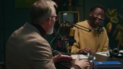 Men recording a podcast in studio setting