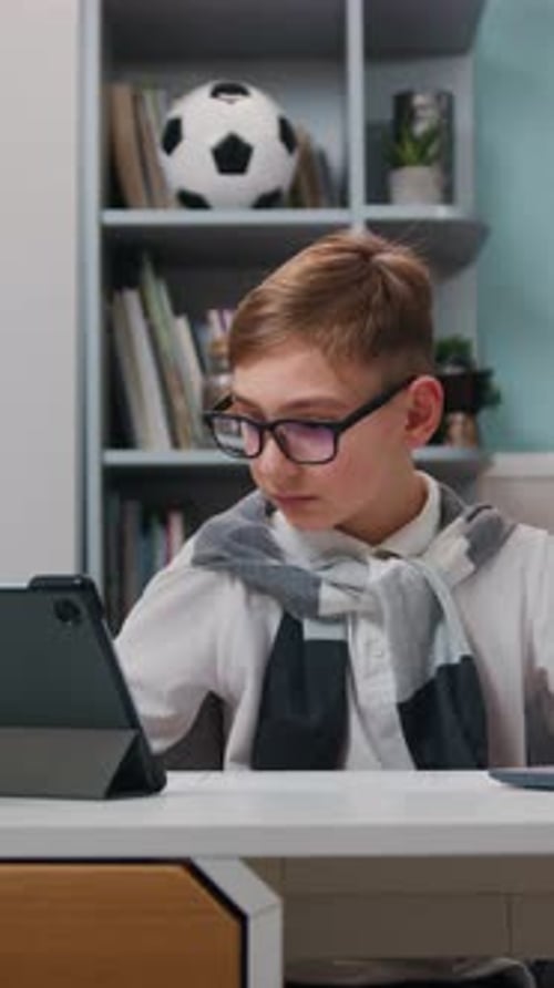 Cute Boy is Doing Homework at Table with Laptop at Home Kid Enjoys Making School Homework Online
