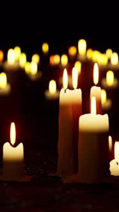 Religious Candles Flickering in Dark Vertical Loop