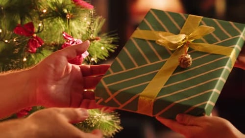 Friends Giving Presents to Each Other Top View Celebrating New Year Sitting at Dining Table