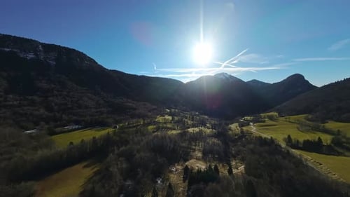 Aerial view of a mountain behind a mountain forest