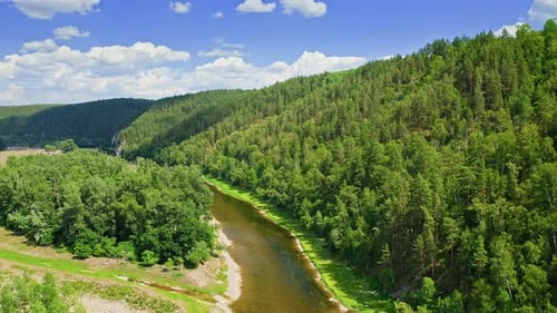Aerial View of River Surrounded By Green Forest and Mountains