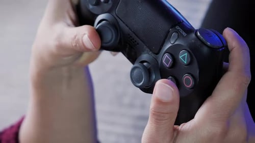 Close up of hands holding video game wireless joystick. Vertical video