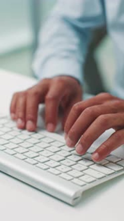 Hands Typing on Modern Computer Keyboard in Office