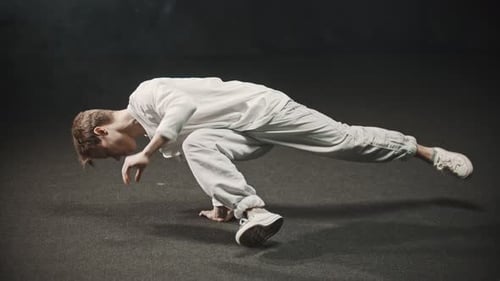 Young Man Training His Dancing in the Studio Leaning on