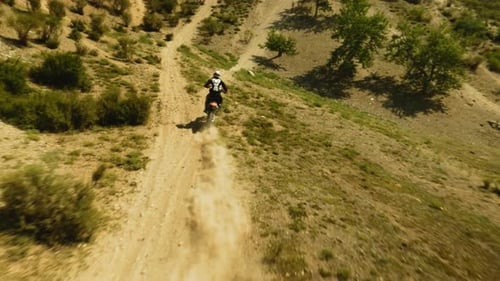 Motorbiker Rides Vehicle Along Ground Road Fpv