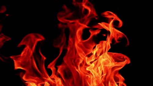 Top of the big bonfire moving in the wind. Close view on the flame burning at night.