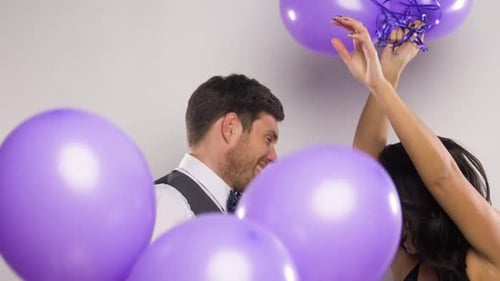 Happy couple celebrate with balloons